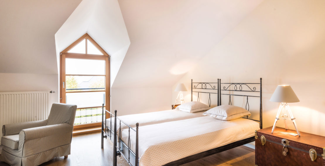 Twin beds and armchair in a hotel room