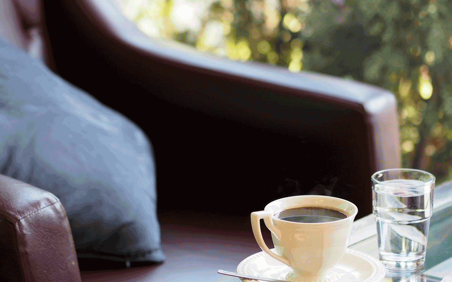 Cup of coffee and glass of water on a table